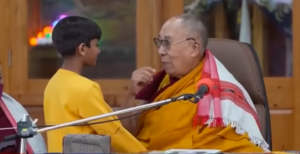 Dalai Lama besa a un niño en la boca en pleno evento budista